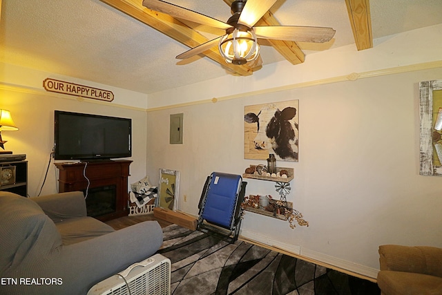 living room with electric panel, ceiling fan, beamed ceiling, and hardwood / wood-style floors