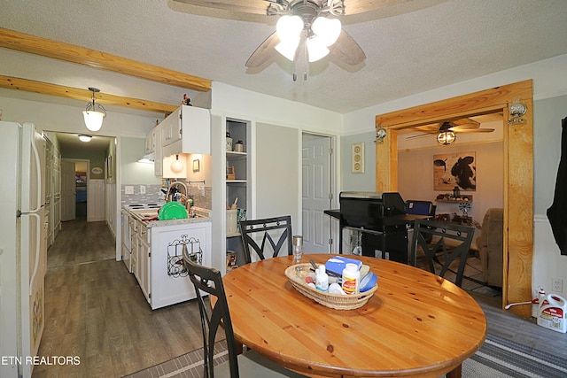 dining space with dark hardwood / wood-style flooring, a textured ceiling, and ceiling fan