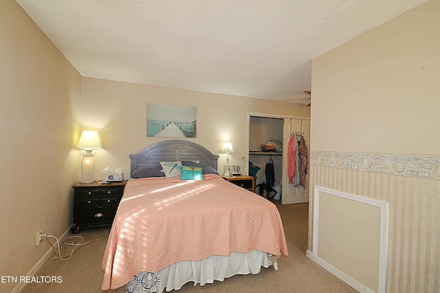 bedroom featuring a closet, a textured ceiling, and carpet floors