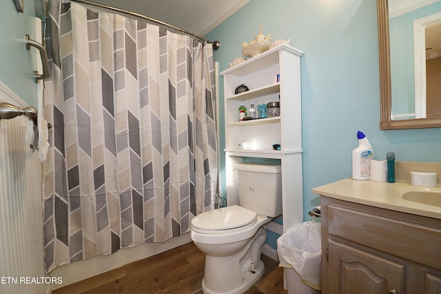 bathroom with vanity, hardwood / wood-style flooring, a textured ceiling, and ornamental molding