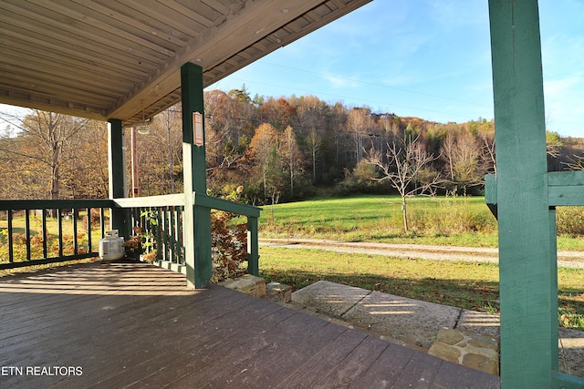 wooden deck featuring a yard