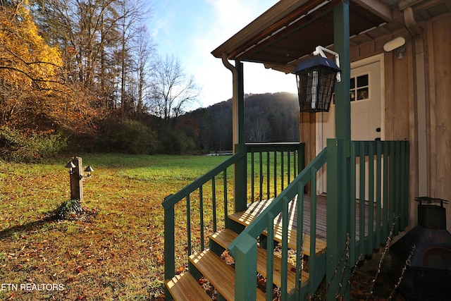 wooden deck featuring a lawn