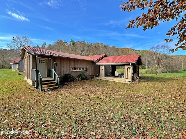 back of house featuring a patio area and a yard