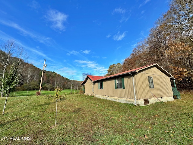 view of side of property with a lawn