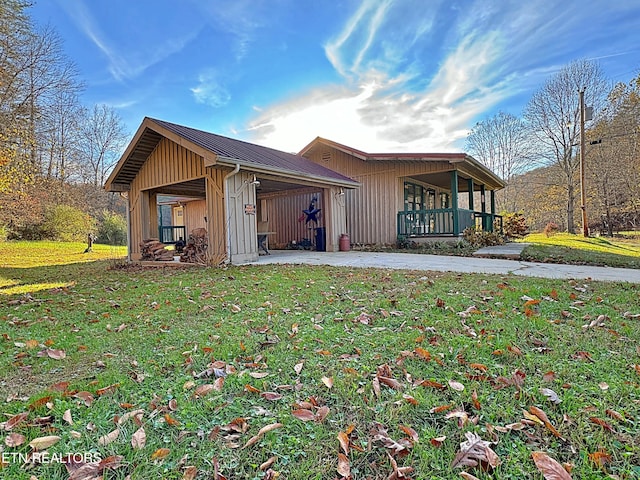 view of side of home with a lawn