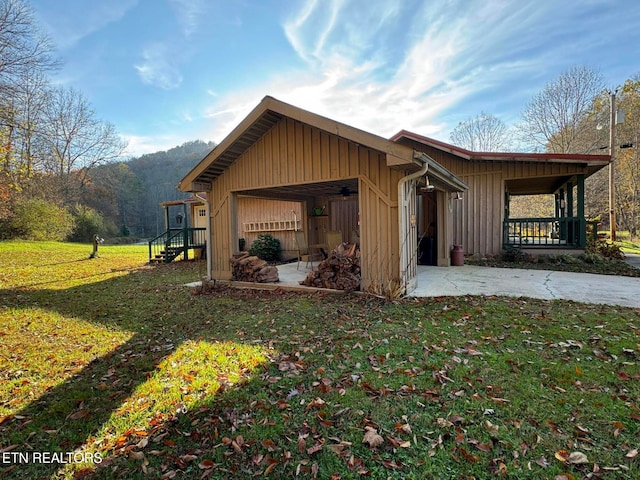 view of side of property with a yard and a porch