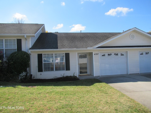 single story home featuring a front yard and a garage