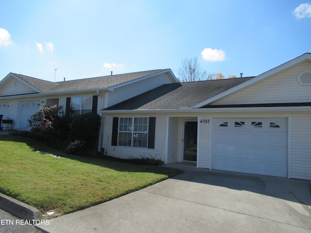 single story home featuring a front yard and a garage