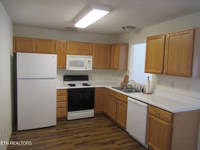 kitchen with white appliances, a textured ceiling, sink, and dark hardwood / wood-style floors