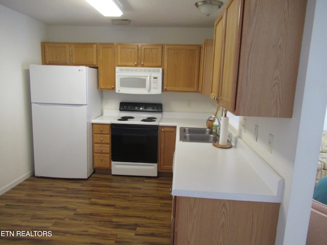 kitchen with sink, dark wood-type flooring, and white appliances