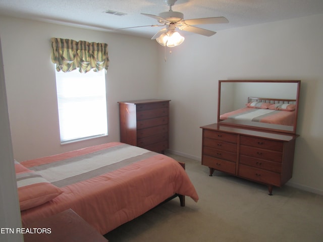 bedroom featuring light carpet and ceiling fan