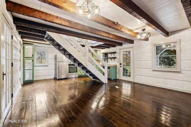 unfurnished living room featuring beamed ceiling, wood walls, hardwood / wood-style flooring, and wood ceiling