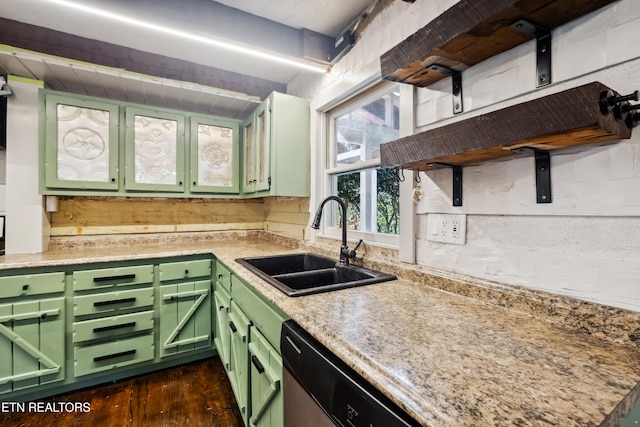 kitchen with green cabinetry, dark hardwood / wood-style flooring, light stone countertops, sink, and dishwasher