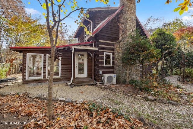 rear view of property with ac unit