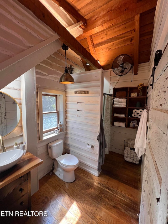 bathroom featuring vaulted ceiling with beams, vanity, hardwood / wood-style floors, toilet, and wooden ceiling