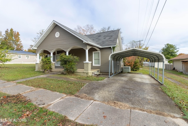 bungalow-style home featuring a carport, covered porch, and a front lawn