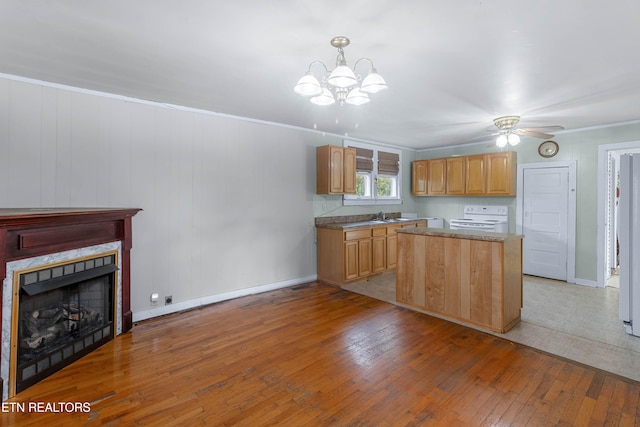 kitchen featuring ornamental molding, ceiling fan with notable chandelier, decorative light fixtures, white stove, and light wood-type flooring