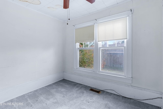 carpeted empty room featuring ceiling fan