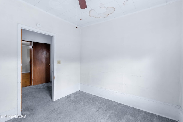 unfurnished room featuring dark colored carpet and ceiling fan