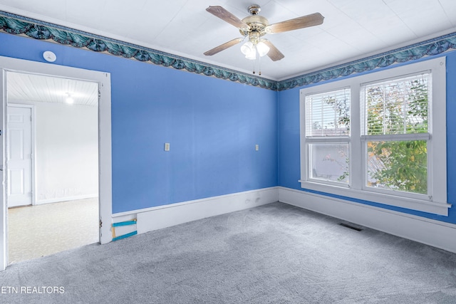 carpeted spare room with ceiling fan