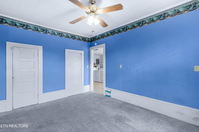 spare room with ceiling fan, carpet flooring, and washer and dryer