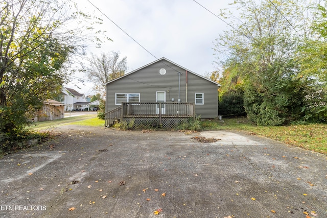 back of house with a wooden deck