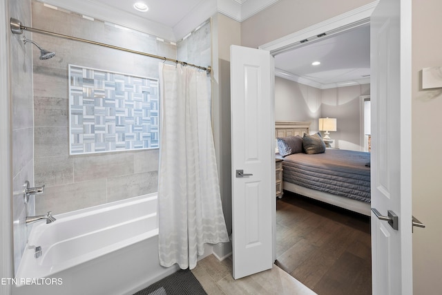 bathroom featuring hardwood / wood-style flooring, shower / bath combination with curtain, and crown molding