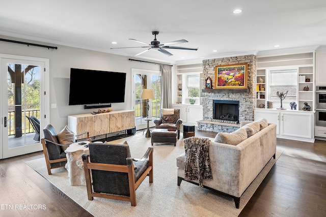 living room with hardwood / wood-style flooring, ceiling fan, plenty of natural light, and ornamental molding