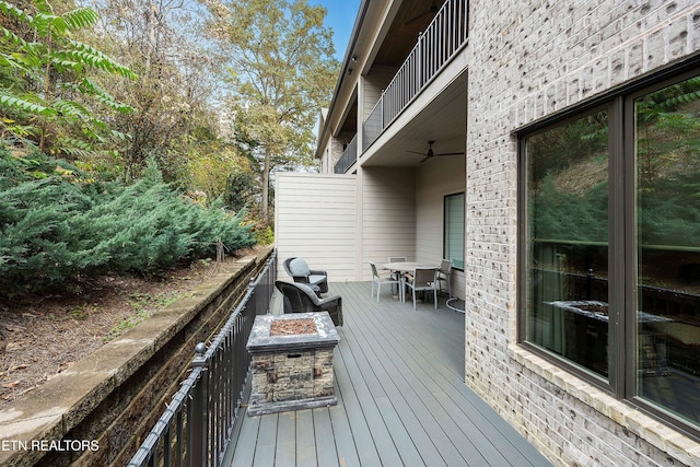 wooden terrace featuring an outdoor fire pit