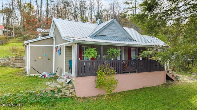 exterior space featuring covered porch and a front lawn