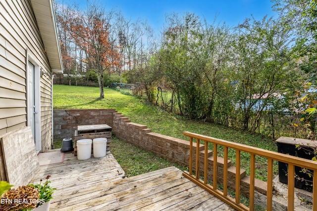 wooden deck featuring a yard