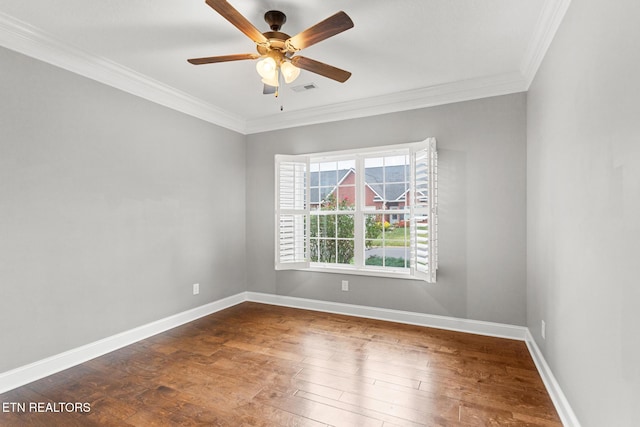 unfurnished room with hardwood / wood-style floors, ornamental molding, baseboards, visible vents, and a ceiling fan