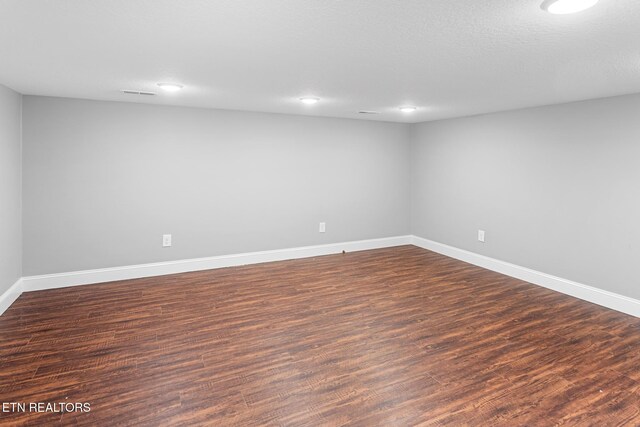interior space featuring baseboards, wood finished floors, and recessed lighting