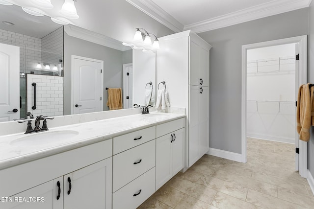 full bathroom featuring double vanity, a sink, crown molding, and a shower stall