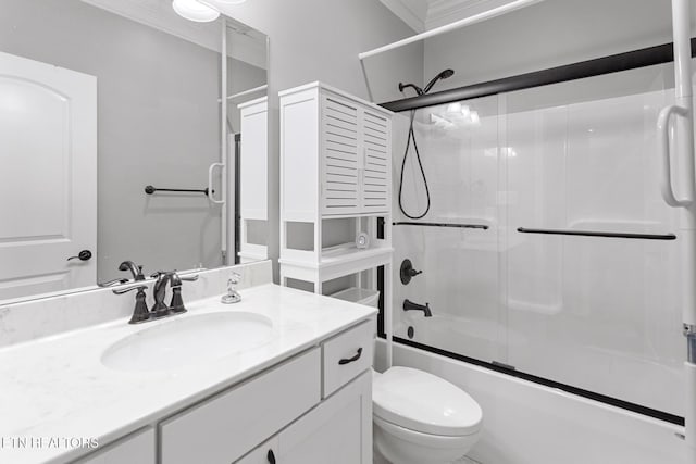 full bathroom featuring toilet, vanity, and shower / bath combination with glass door