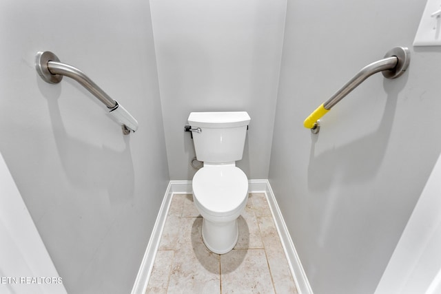bathroom with toilet and baseboards