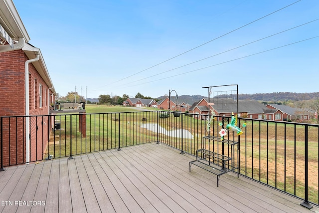 deck with a residential view and a lawn