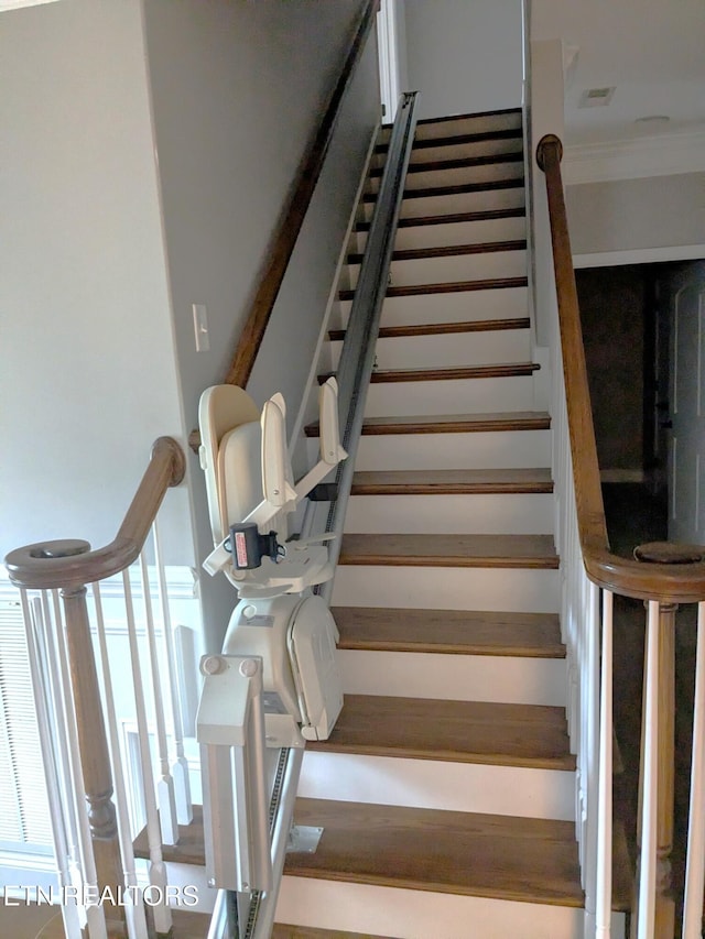 stairway featuring crown molding