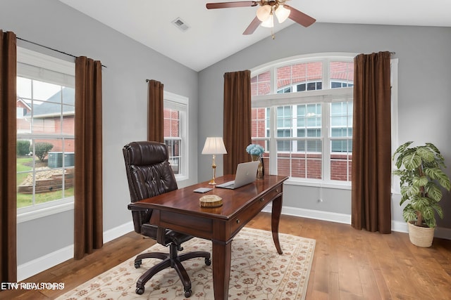 home office with light wood-style flooring, a healthy amount of sunlight, ceiling fan, and visible vents