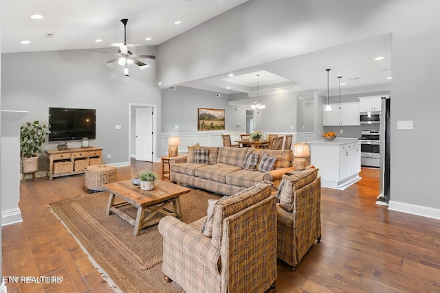 living room with baseboards, dark wood-style floors, recessed lighting, and ceiling fan with notable chandelier