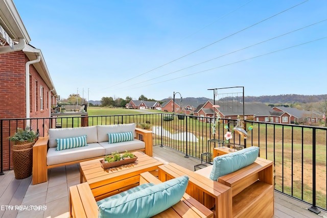 wooden deck with an outdoor living space and a residential view