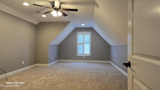 bonus room featuring baseboards, visible vents, a ceiling fan, and light colored carpet