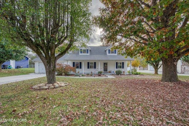 view of front of property with a garage, covered porch, and a front lawn