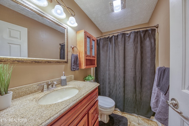 bathroom featuring tile patterned floors, a shower with curtain, vanity, a textured ceiling, and toilet