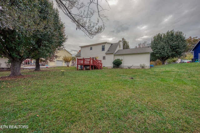 view of yard with a garage and a deck