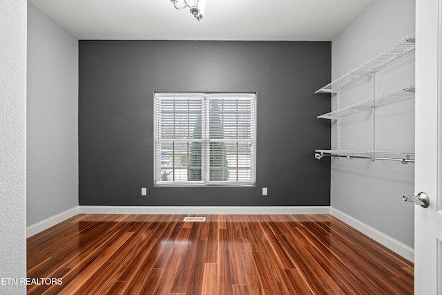 unfurnished room featuring hardwood / wood-style flooring