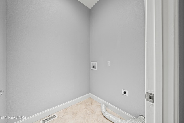 clothes washing area with laundry area, visible vents, electric dryer hookup, washer hookup, and baseboards