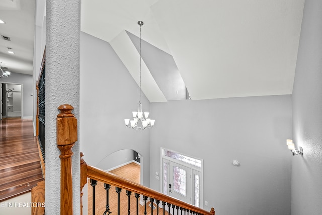 interior details with wood-type flooring and a chandelier