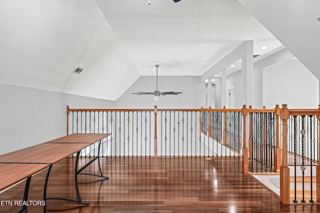 corridor featuring vaulted ceiling and hardwood / wood-style flooring