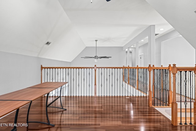 hall with lofted ceiling, recessed lighting, visible vents, and wood finished floors